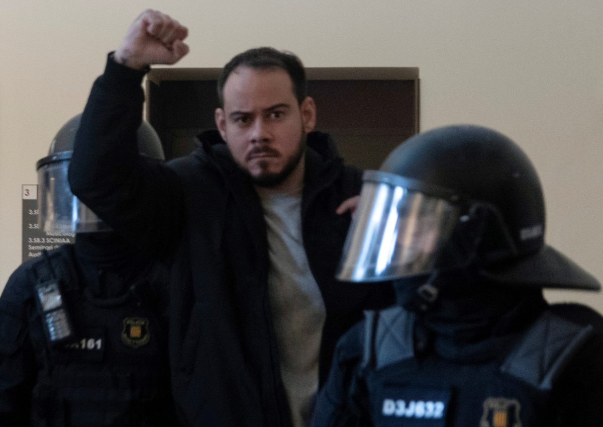 Spanish rapper Pablo Hasel reacts as he is detained by riot police inside the University of Lleida, after he was sentenced to jail time on charges including insulting the monarchy and glorifying terrorism, in Lleida, Spain February 16, 2021. REUTERS/Lorena Sopena