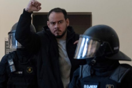 Spanish rapper Pablo Hasel reacts as he is detained by riot police inside the University of Lleida, after he was sentenced to jail time on charges including insulting the monarchy and glorifying terrorism, in Lleida, Spain February 16, 2021. REUTERS/Lorena Sopena