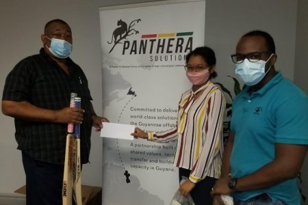 Cristal Smith and Ray McLean of Panthera Solutions hand over the donation to Hilbert Foster.