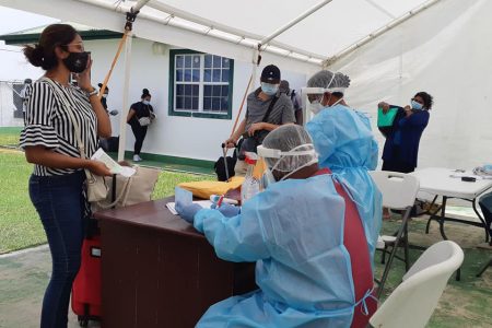 Arriving passengers from Suriname being processed by health workers at the Canawaima Ferry Stelling (Ministry of Public Works photo)