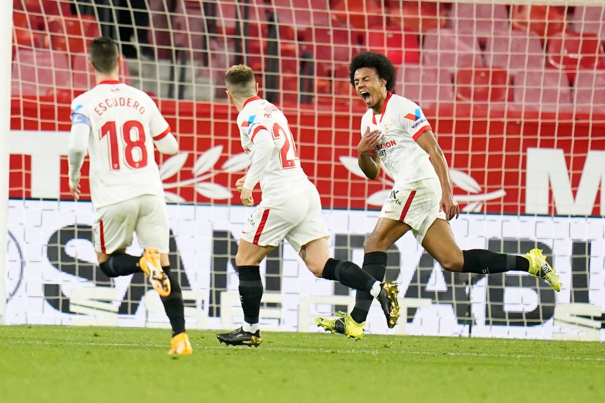 Sevilla players celebrate a goal against Barcelona.
