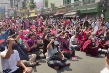 People gesture as they protest against coup in Yangon, Myanmar February 6, 2021 in this screen grab obtained from a video. DVB TV NEWS/Reuters TV/via REUTERS