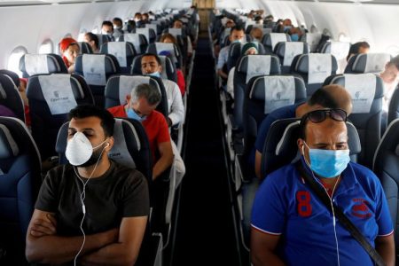 Passengers wearing protective face masks sit on a plane at Sharm el-Sheikh International Airport, following the outbreak of COVID-19 in Sharm el-Sheikh, Egypt, June 20, 2020. (REUTERS/Mohamed Abd El Ghany file photo)