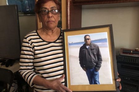Jaipaul Persaud’s mother, Merlyne Persaud holding a photo of him.  (Ellen Moynihan for New York Daily News photo)