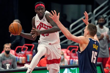 Pascal Siakam (left) of the Toronto Raptors attempting a pass while being guarded by Nikola Jovic of the Denver Nuggets