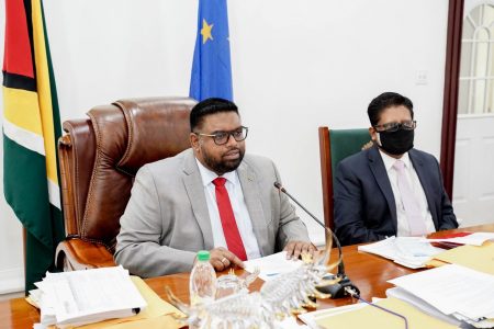 President Irfaan Ali (left) addressing the conference yesterday. At right is Minister with responsibility for finance Dr Ashni Singh. (Office of the President photo)