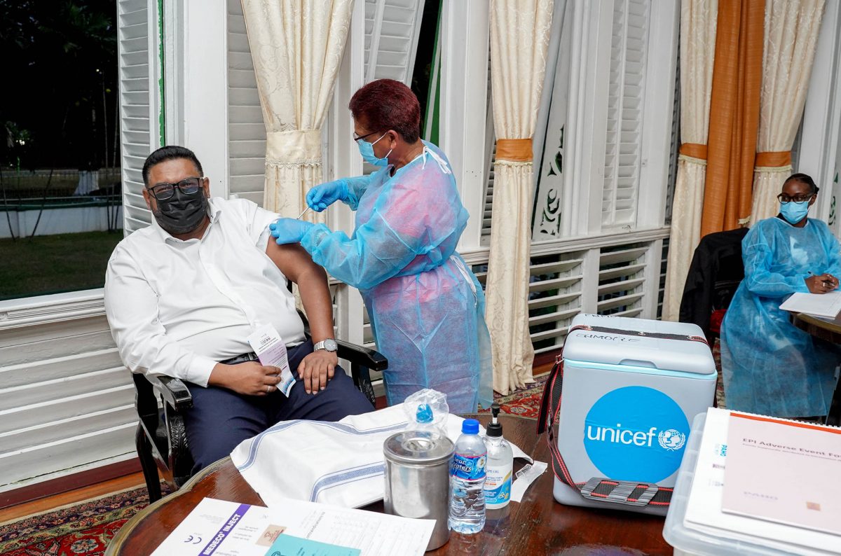 President Irfaan Ali receiving his first dose of the COVID-19 vaccine on Friday (Office of the President photo)