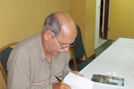 Robert “Bobby” Fernandes signing a copy of his book, Short and Sweet, at the launching in 2008