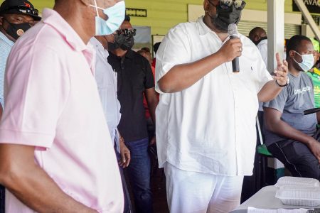 President Irfaan Ali with microphone appealing to the spectators. (Office of the President photo) 