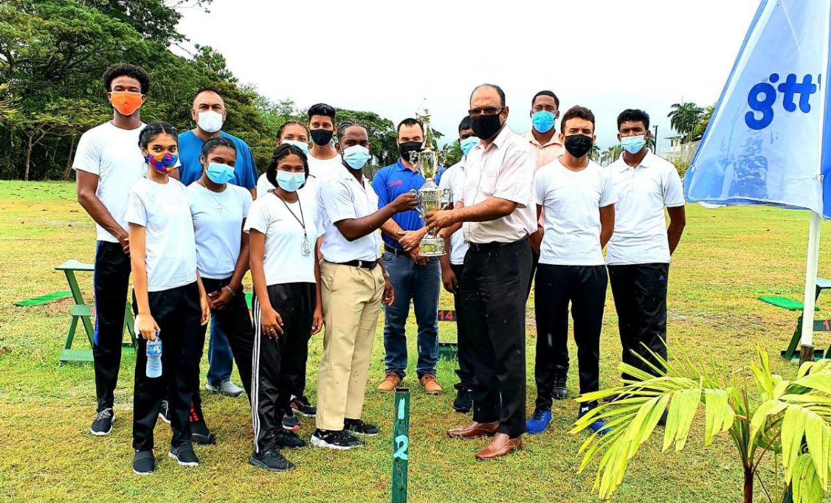 Senior Education Officer Sadiek Ishmael, Nicholas Fraser and Guyana Golf Association president Aleem Hussain  presenting the trophy for the first Inter-Schools golf shampionships to members of the winning team from the Berbice Educational Institute at the Nexgen Golf Academy on Woolford Avenue recently.