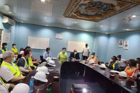 Minister of Public Works Juan Edghill at head of table during a meeting at the airport today. (Ministry of Public Works photo)