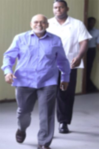 Former President Donald Ramotar (left) at court for one of the hearings