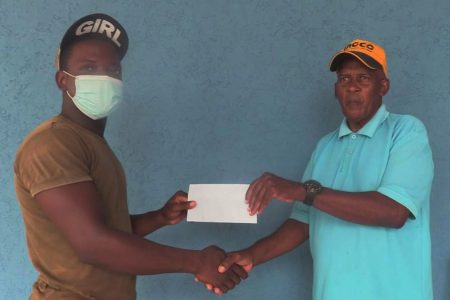 Flying Ace Cycling Club, Randolph Roberts (right) receives the sponsorship from KPX2 Hollow & Design Blocks’ Mervin Clarke.