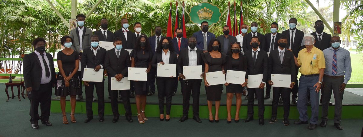 The 17 new land surveyors with President Irfaan Ali (centre in back row) and other officials including Commissioner (ag) of the Guyana Lands and Survey Commission (GL&SC) Enrique Monize (sixth from left in back row) after receiving their instruments of practice. (Department of Public Information photo)