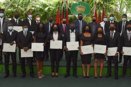 The 17 new land surveyors with President Irfaan Ali (centre in back row) and other officials including Commissioner (ag) of the Guyana Lands and Survey Commission (GL&SC) Enrique Monize (sixth from left in back row) after receiving their instruments of practice. (Department of Public Information photo)