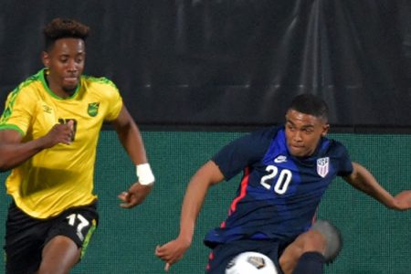 Jamaica’s Jamal Lowe clashes with United States full back Reggie Cannon during their international friendly on Thursday. 