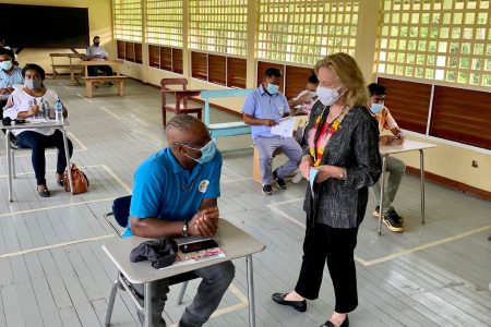 US Ambassador to Guyana, Sarah-Ann Lynch (standing at right) conversing with one of the trainees (US Embassy photo)