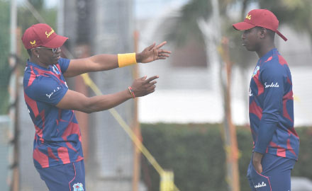 LEADING THE WAY: Veteran all-rounder Dwayne Bravo makes a point to uncapped off-spinner Kevin Sinclair. (Photo courtesy CWI Media) 