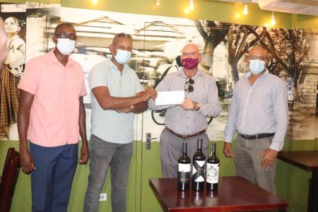 Lusignan Golf Club treasurer, Maxim `Danny’ Mangra (second from left) receives the sponsorship cheque from Oasis Café’s William Walker in the presence of President Patanjalee Persaud (right) and Vice-President Paton George (left).