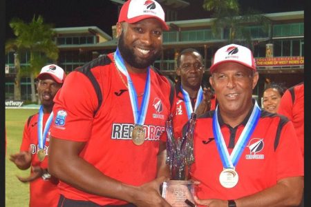 The Red Force had a dominant victory in last Saturday’s final, by 152 runs over the Guyana Jaguars in the CG Insurance Regional Super50 tournament, and a perfect record in winning all seven matches. Skipper Kieron Pollard, left, and head coach David Furlonge lifted the Sir Clive Lloyd trophy.  (Courtesy CWI)