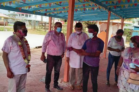 Visits to Mandirs: Minister with responsibility for Finance, Dr Ashni Singh (left) yesterday visited several Mandirs throughout Region 6 as he took part in the Phagwah festivities among small gatherings. Some of the Mandirs visited included Crabwood Creek Mandir, Springlands Mandir, #67 Mandir, Bush Lot Mandir, Whim South Mandir, Tain Mandir, #19 Mandir.  (Ministry of Finance photo)
