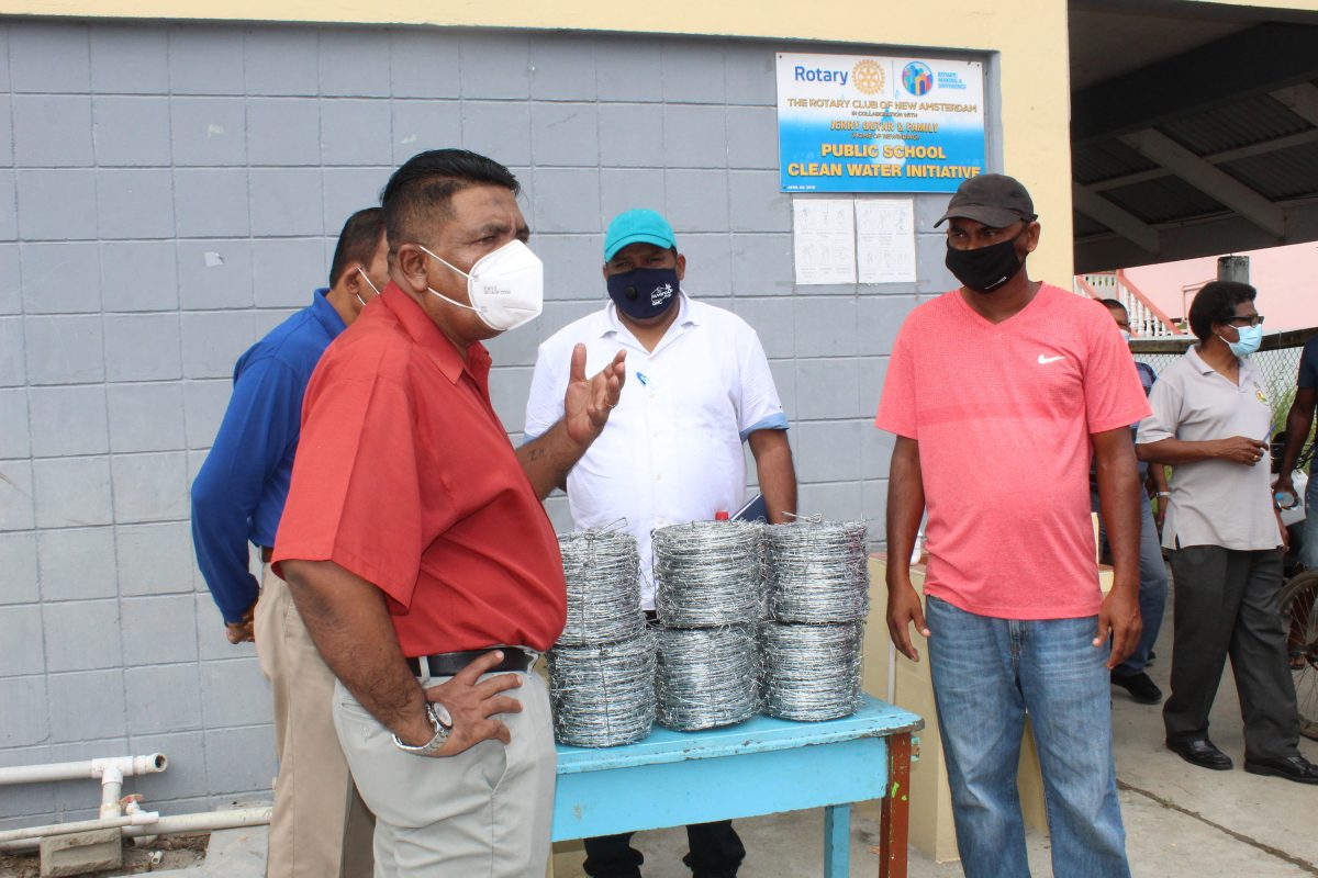 Minister of Agriculture, Zulfikar Mustapha (left) handing over the wire to an Upper Corentyne farmer. 