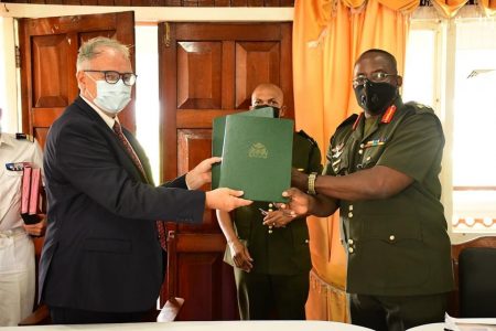 Guyana Defence Force  Chief of Staff Brigadier Godfrey Bess (right) and French Non-Resident Ambassador to Guyana Antoine Joly exchanging the signed document. (GDF photo)