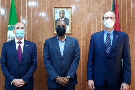 Joseph Harmon (centre) with  ExxonMobil Guyana officials.