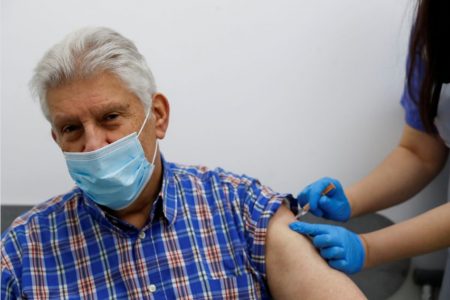 An elderly person receives a dose of the Oxford/AstraZeneca COVID-19 vaccine at Cullimore Chemist, in Edgware, London, Britain January 14, 2021. (REUTERS/Paul Childs/file photo)