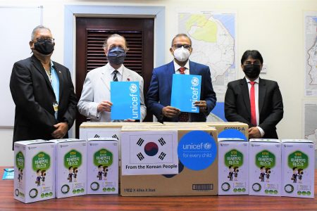 From left are Honorary Consul of the Republic of Korea in Guyana Ramesh Dookhoo, Minister of Health Dr Frank Anthony, UNICEF Representative Nicolas Pron and UNICEF Deputy Representative Irfan Akhtar at the symbolic handover of 20,000 pieces of high-quality KF94 face masks to the Ministry of Health on Friday. The total donation amounts to 40,000 masks donated by the Republic of Korea, through UNICEF for frontline workers. (UNICEF photo)