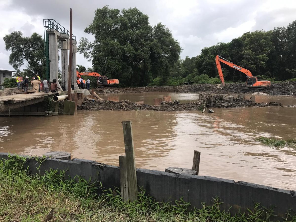 Excavators working to seal the breach in the vicinity of the new sluice 