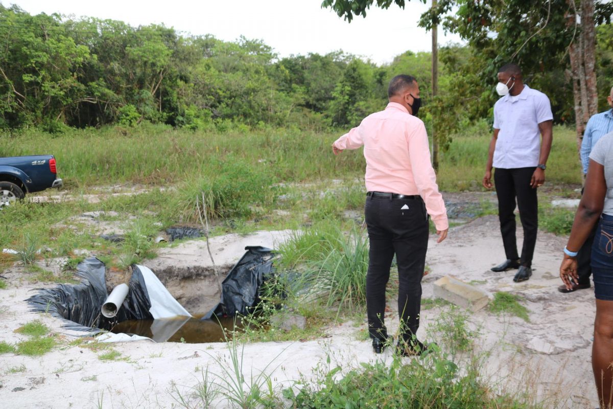 Minister of Housing and Water, Collin Croal (left) visiting the location of the well which was abandoned after the drilling work started (Ministry of Housing and Water photo)