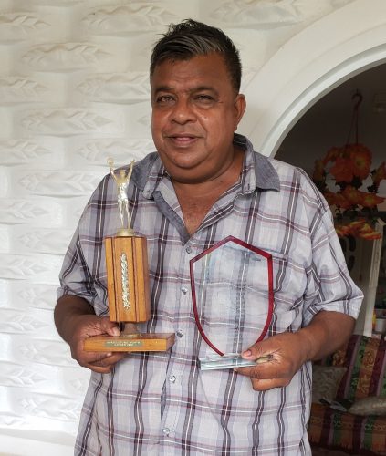 Pitamber Panday with awards he has received for service to the livestock sector 
