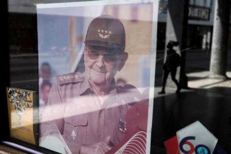 A picture of former Cuban President Raul Castro is displayed in the window of a state building in Havana, Cuba, April 11, 2021. REUTERS/Alexandre Meneghini