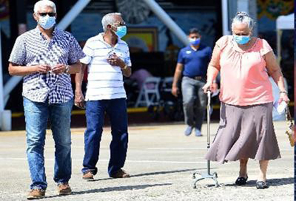Halfway there: A group of people leave the Grand Stand, Queen’s Park Savannah, Port of Spain, last Sunday after receiving their first dose of the AstraZeneca Covid-19 vaccine.  (Trinidad Express photo)
