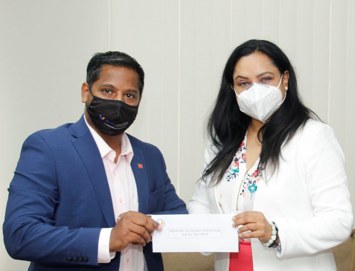 Vitality Inc Director Abbas Hamid hands over the $1M cheque to Dr Vindhya Persaud (Human Services and Social Security Ministry photo) 