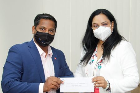 Vitality Inc Director Abbas Hamid hands over the $1M cheque to Dr Vindhya Persaud (Human Services and Social Security Ministry photo) 