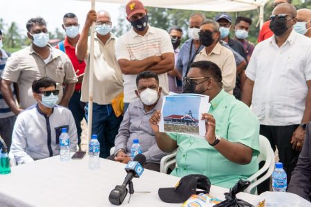President Irfaan Ali visited the Essequibo River island of Leguan yesterday morning in relation to a commitment to residents who had sought his help for the establishment of a crematorium.
A release from the Office of the President said that the $25M-$30M facility is to be fully funded by the Ramroop Foundation with work set to begin in less than two weeks. This Office of the President photo shows the President holding up a depiction of what the crematorium will look like.