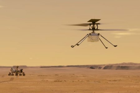 FILE - This illustration made available by NASA depicts the Ingenuity helicopter on Mars which was attached to the bottom of the Perseverance rover, background left. (NASA/JPL-Caltech via AP)