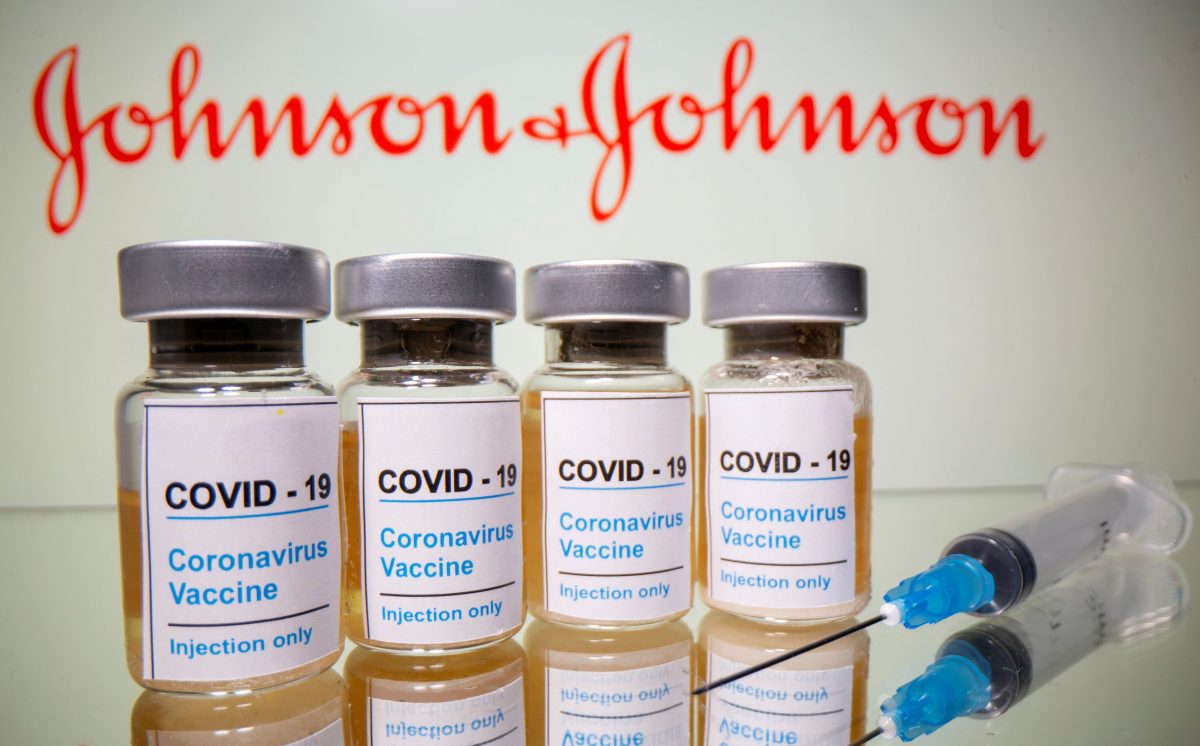 FILE PHOTO: Vials with a sticker reading, “COVID-19 / Coronavirus vaccine / Injection only” and a medical syringe are seen in front of a displayed Johnson & Johnson logo in this illustration taken October 31, 2020. REUTERS/Dado Ruvic/Illustration/File Photo
