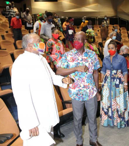 Prime Minister Dr Keith Rowley is given an elbow bounce by an unidentified man on his arrival to the PNM’s Spiritual Shouter Baptist Liberation Day celebration at the Government Campus Plaza Auditorium in Port-of-Spain, on March 27.