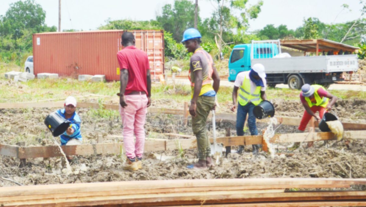 Construction workers undertaking foundation works for one of the homes 