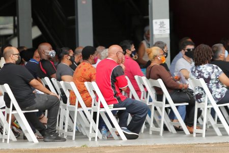 Members of the public wait to get the COVID-19 vaccine at the Grand Stand, Queen’s Park Savannah, Port-of-Spain, last Sunday.