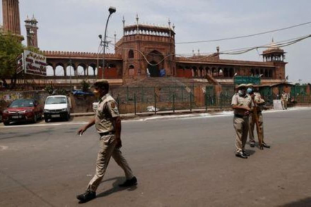 Policemen stand in front of Jama Masjid or Grand Mosque on Jumat-ul-Vida or the last Friday of the holy fasting month of Ramadan, during a lockdown to limit the spread of the coronavirus disease (COVID-19), in the old quarters of Delhi, India, May 7, 2021. REUTERS/Adnan Abidi