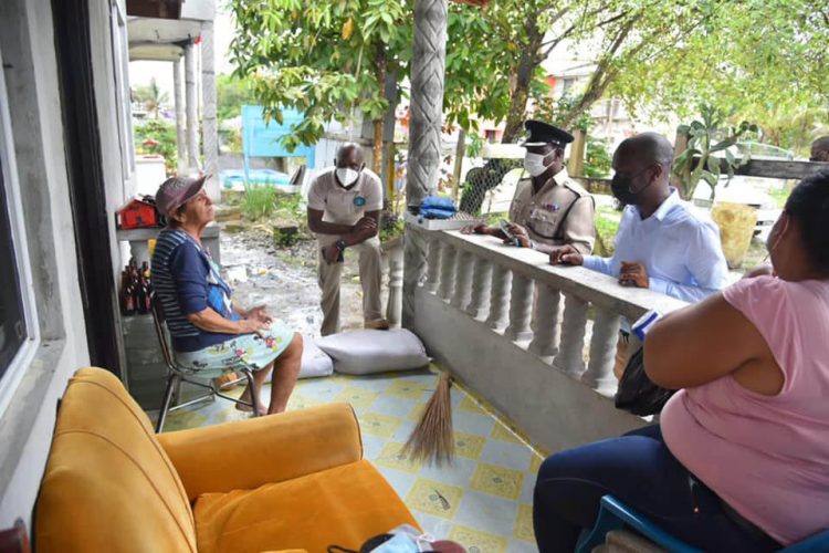 Director General of the Civil Defence Commission, Lt. Col. Kester Craig (second from right) met and interacted with flood-affected residents yesterday. (DPI photo)