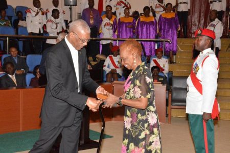 Leader of the People’s National Congress David Granger (then president) presenting the Medal of Service to Daphne Rogers in 2016.