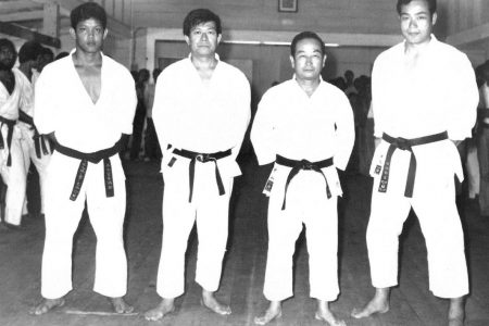 This historical photograph shows 24-year-old Frank Woon-A-Tai, second dan, posing with Masters:
Teruyuki Okazaki, Masatoshi Nakayama, and Yukichi Tabata at Legionnaires Hall, Georgetown. 1974