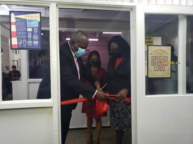 Prime Minister Mark Phillips (left) along with the President of the Guyana Philatelic Society Ann Wood (centre) and a representative of the GPOC during the ribbon cutting ceremony.
