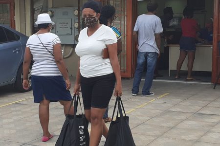 A San Fernando West consitituent leaves the the office of the MP Faris Al-Rawi on Independence Avenue, San Fernando, yesterday with relief hampers which were donated by NAMDEVCO in partnership with the Ministry of Social Development.	