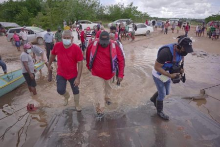 President Irfaan Ali (at centre) during a visit to Kwakwani to evaluate the impact of flooding in the community on Saturday. (Office of the President photo) 
